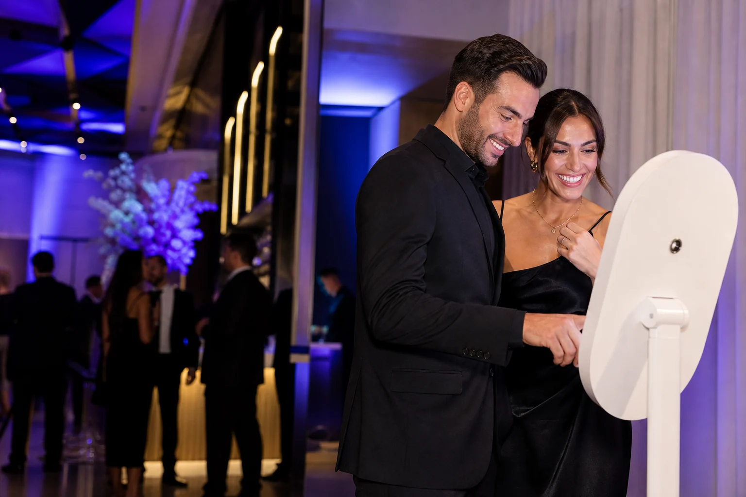 Guests using a professional photo booth at an upscale event